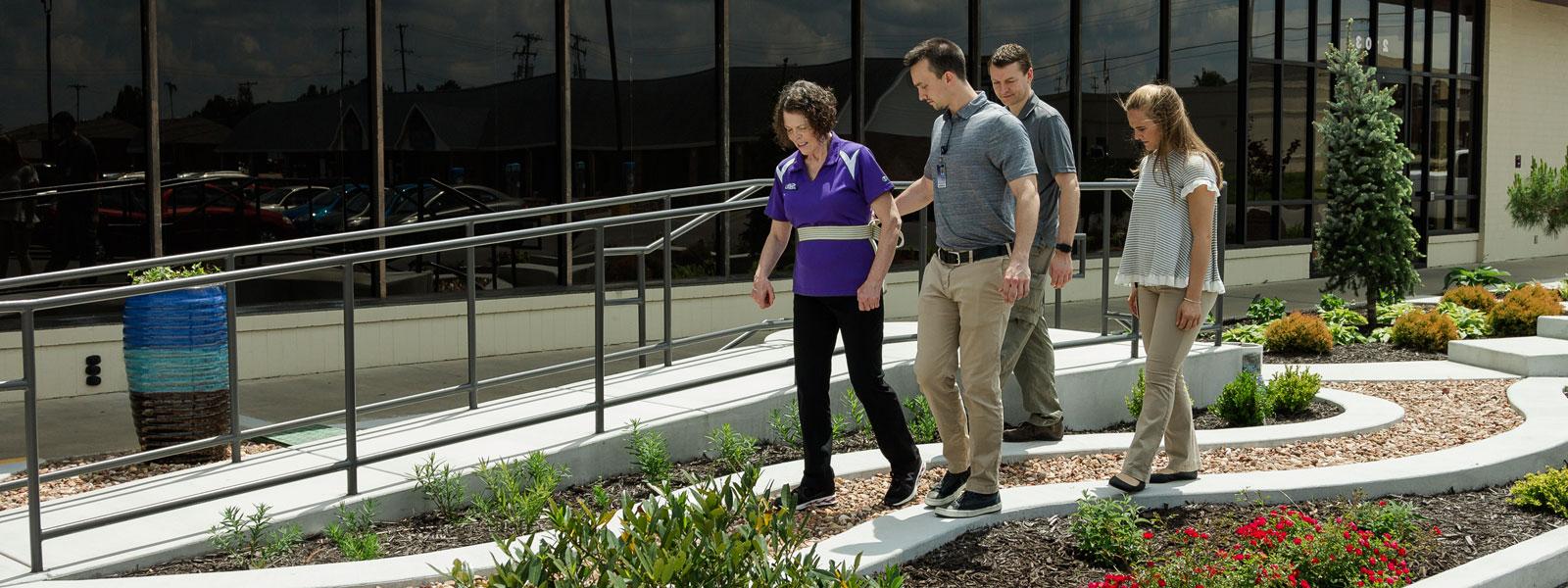 physical therapy students perform grip test with clinic patient